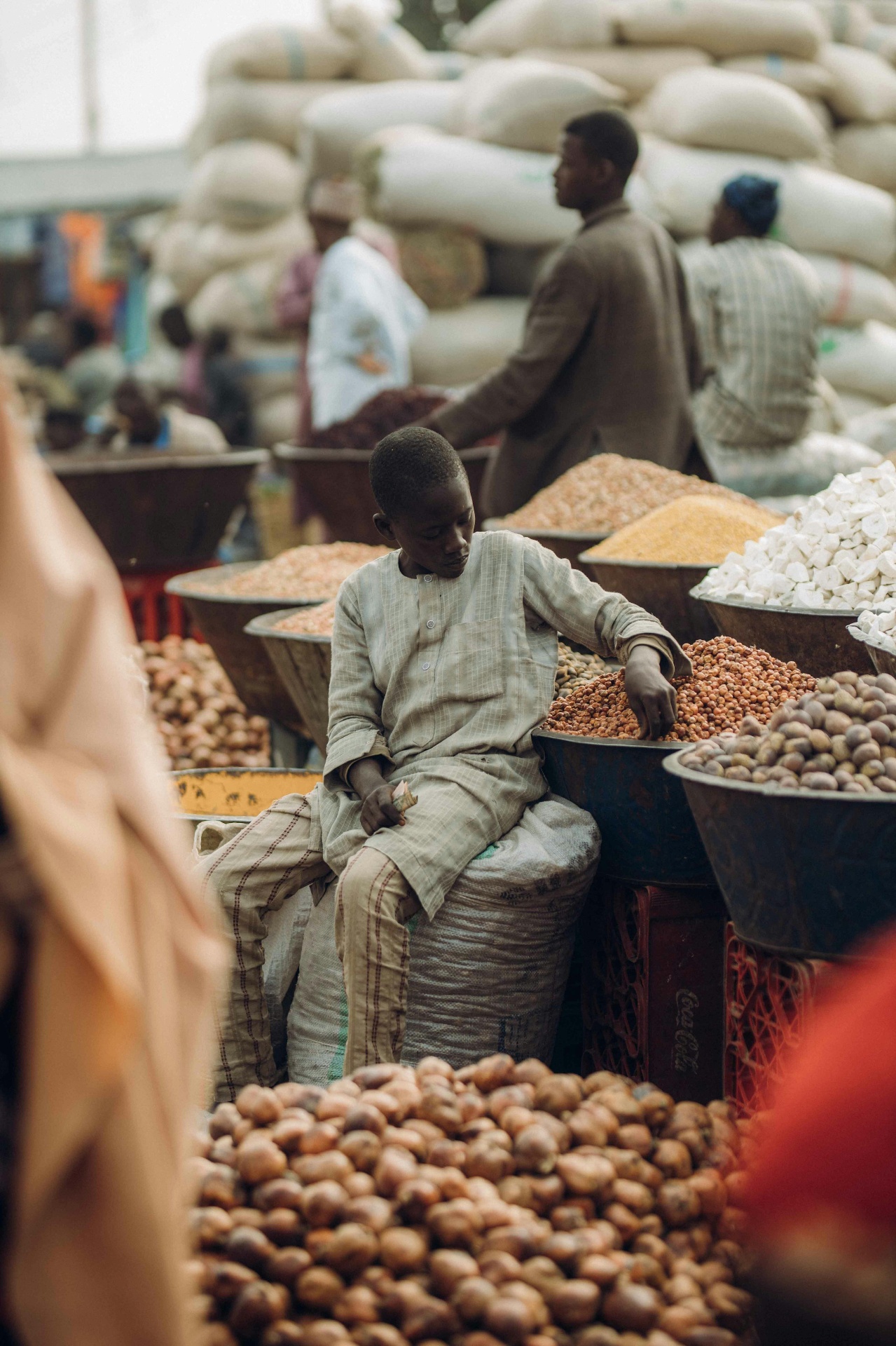 A young boy at a community market — symbolizing the everyday lives we walk alongside